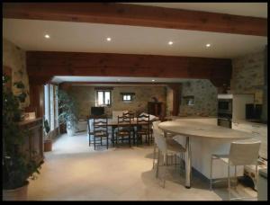 a kitchen and dining room with a table and chairs at Chez Baptistète in Labastide