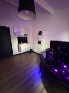 a living room with purple lights on the floor at maison romantique avec spa privé in Montargis