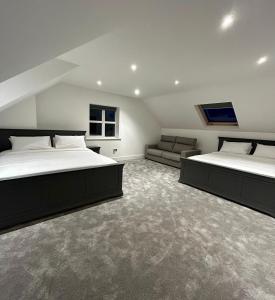 a large bedroom with two beds and a couch at Modern house Boyle in Boyle
