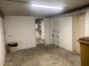 an empty room with a garage with a room with a wall at Maison Mylan, simple and practical! in Cholet +24 photos