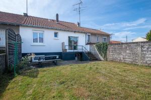 a house with a fence and a bench in a yard at Maison Mylan, simple and practical! in Cholet