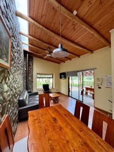 a living room with a wooden table and a couch at Olmue Natura Lodge & Spa in Olmué