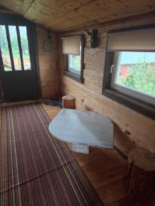 a living room with a table and a window at Chata Między Górami in Zalesie