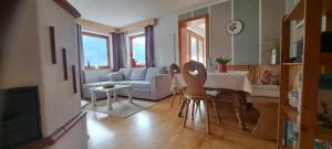 a living room with a couch and a table at Fewo Hereinspaziert in Schwendau