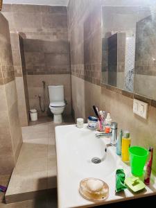 a bathroom with a sink and a toilet at Bizerta Méditerranée in Bizerte +19 photos