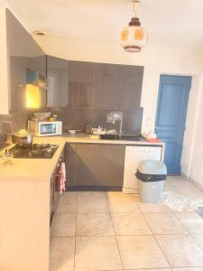 a kitchen with a sink and a stove top oven at Maison à louer in Valence