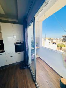 a kitchen with a large glass door and a window at Bizerta Méditerranée in Bizerte