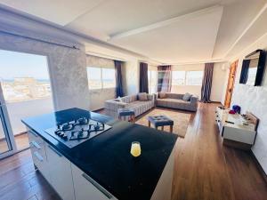 a kitchen and living room with a stove top oven at Bizerta Méditerranée in Bizerte