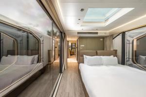 two beds in a room with a window at Kassland Resort & Spa -By Kassland Hotels in Ma'ale Adumim +134 photos