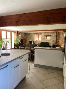 a kitchen with white cabinets and a dining room at Chez Baptistète in Labastide