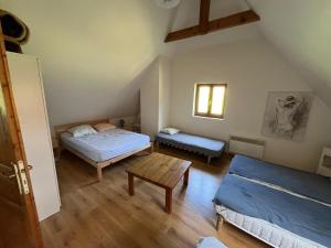 a room with two beds and a table in it at Chez Baptistète in Labastide +7 photos