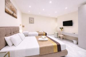 a hotel room with a bed and a television at Sicily Luxury Suites in Palermo +66 photos