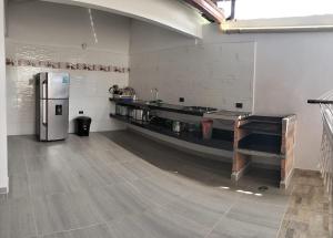 a large room with a kitchen with a refrigerator at Villa Liam Casa Turística in Prado