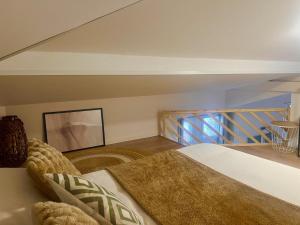 a bedroom with a bed and a staircase at Le Cocon du Mont'Anay in Montanay