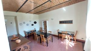 a dining room with wooden tables and chairs at Cascina Barosca in Castelnuovo Don Bosco +36 photos