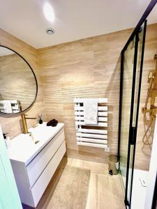 a bathroom with a white sink and a mirror at Le Cocon du Mont'Anay in Montanay +19 photos