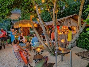 a group of people sitting at a restaurant on the beach at Klaushausen Ferienoase in Überlingen
