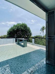 a bench on a patio with a view of the ocean at The Grey House in Bacong