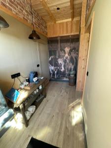 a room with a painting of a cow on the wall at B&B Opoes huusie in Lutten