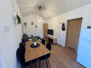 a living room with a table and a refrigerator at Kuća za odmor Mia in Gornja Gračenica