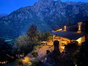a house with a view of a mountain at night at Maison de charme en pierre in Porto Ota