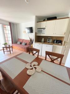 a kitchen and a living room with a table at Séjour 4 personnes - Pays Basque in Uhart-Cize
