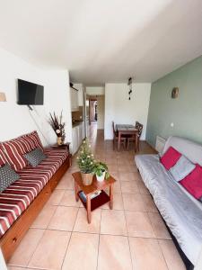 a living room with a couch and a table at Séjour 4 personnes - Pays Basque in Uhart-Cize