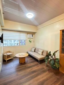 a living room with a couch and a table at Ilo2stayAirbnb 1BR 334 in Molo