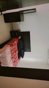 a view of a bed in a room at Taj Plaza in Sowayma