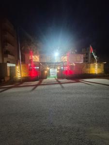 an empty street at night with red lights at Taj Plaza in Sowayma