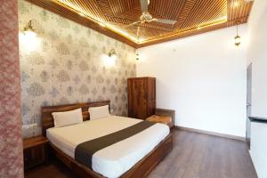 a bedroom with a bed and a ceiling at The Kandarp Villa in Jaipur
