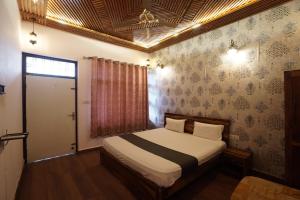 a bedroom with a bed in a room at The Kandarp Villa in Jaipur
