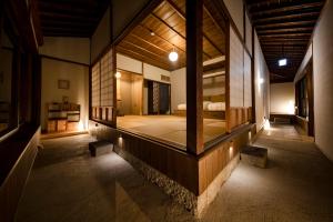 a room with a bed in the middle of it at 3000平米の元醤油名家邸宅, 日本庭園, 蔵Bar, サウナ, 出張料理, フルサービスの宿 in Shodoshima