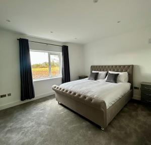 a bedroom with a large bed and a window at Modern house Boyle in Boyle