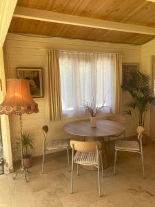 a dining room with a table and chairs and a lamp at Waldchalet in Burgthann