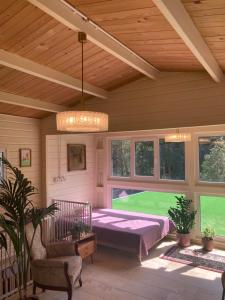 a room with a bed and a ceiling with windows at Waldchalet in Burgthann