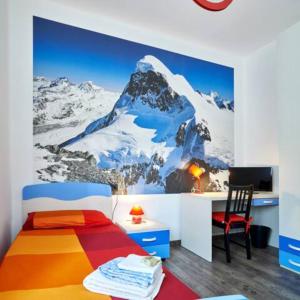 a bedroom with a mountain mural on the wall at Grandi Cime Guest House in Lecco