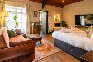 a bedroom with a large bed and a couch at The Crown Hotel in Lynton
