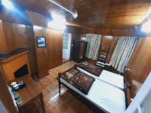 an overhead view of a bedroom with a bed and a table at Himalayan Heritage Stay in Darjeeling