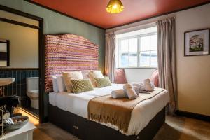 a bedroom with a large bed with a window at The Crown Hotel in Lynton