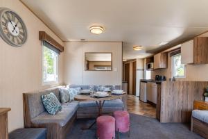 a living room with a couch and a table at Coastal Caravan at Seton Sands -Near Edinburgh in Port Seton