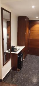 a kitchen with a counter and a sink in a room at Hotel Regalia in Bathinda