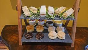 a display of different types of sandwiches and pastries at The White House Hotel in Williton +8 photos