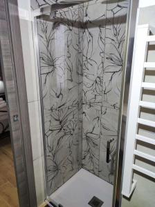 a shower with a black and white wallpaper at 50 Special in Pontedera +40 photos
