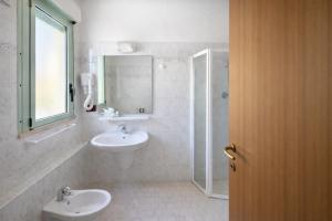 a white bathroom with a sink and a shower at Hotel Dover Rooms & Coffee Adults Friendly in Cervia +49 photos