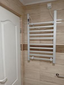 a bathroom with a towel rack on the wall at Villa MIR in Mokra Gora +25 photos