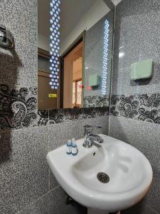 a bathroom with a sink and a mirror at Residence Imlil Ouarzazate in Ouarzazate +25 photos