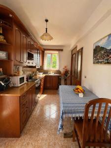 a kitchen with a table with a blue and white table cloth at Jemin Apartment in Berat