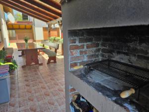 a brick oven with food cooking on it at Guest House Gacka Rogić in Otočac