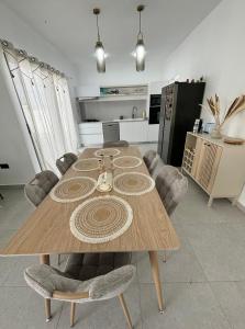 a wooden table with chairs in a kitchen at Villa Le Caprice in Grand-Baie